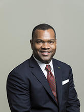 Horace Blackman is wearing a dark sportcoat and red tie