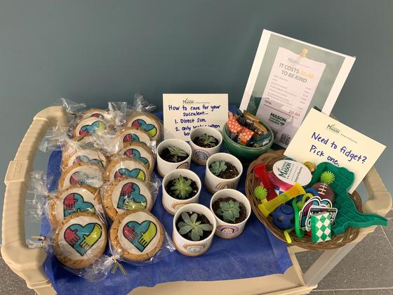 Kindness station in the School of Business has giveaways, treats, and tips on how to spread kindness