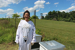 Mason alum Alessandra Castaneda volunteering with the Honey Bee Initiative