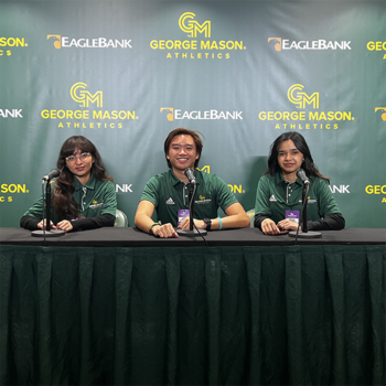 from left: Melissa Quinteros, Cody Salenga, and Manahil Piracha sit behind the microphones at the post-game interview table